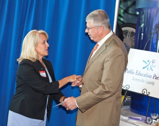 Kathy Weeks, Allen Tate RVP Upstate, presents a check to Greenville County Schools Superintendent W. Burke Royster