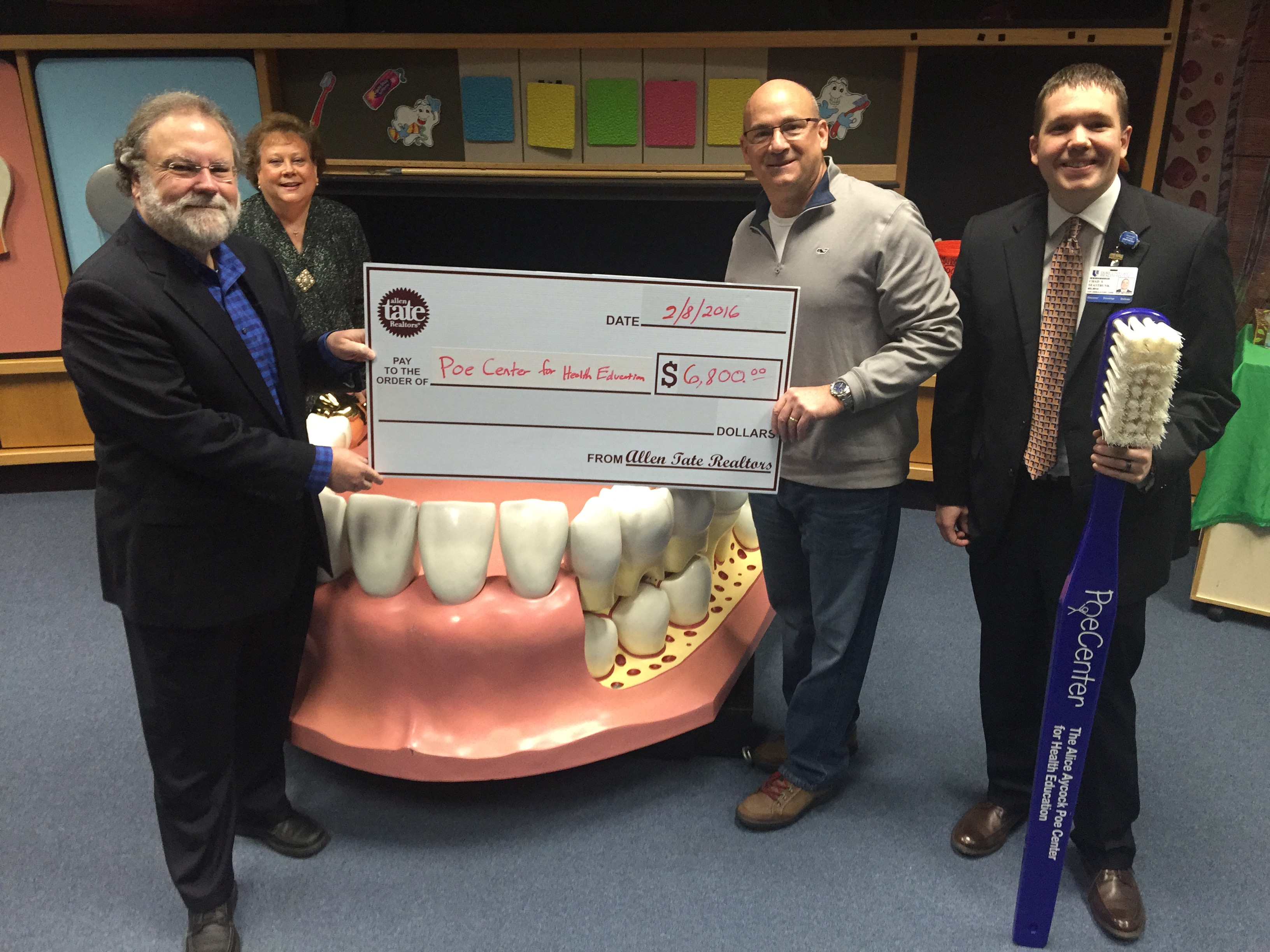 From left: Tom Gongaware, Allen Tate Company general manager; Ann Rollins, Poe Center executive director; Jim McGrath, Poe Center board of directors president; and Chad Seastrunk, Poe Center treasurer.